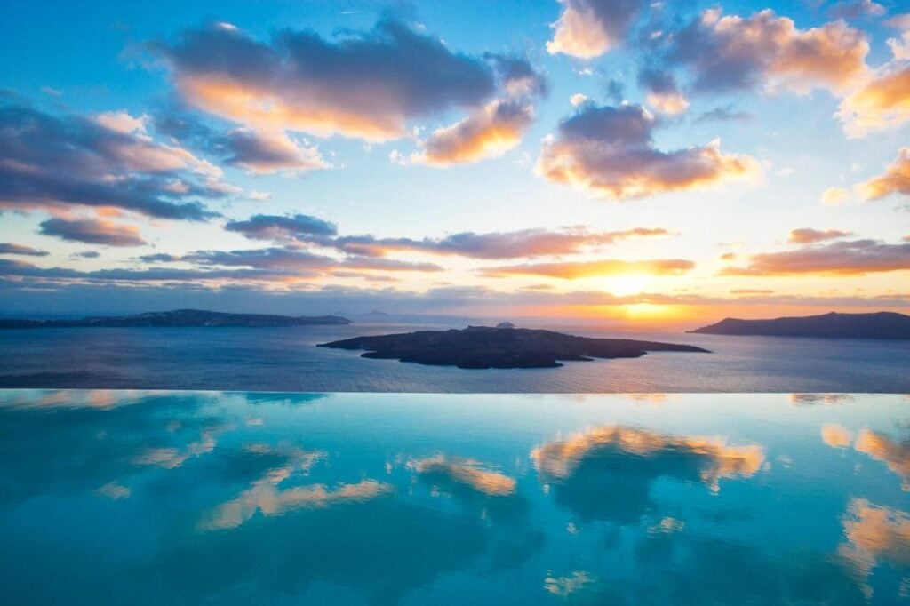 Cosmopolitan Suites infinity pool sunset views with volcano, Santorini