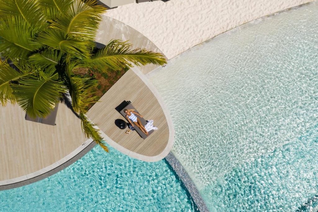 Girl sunbathing at Crystalbrook Riley resort in Cairns