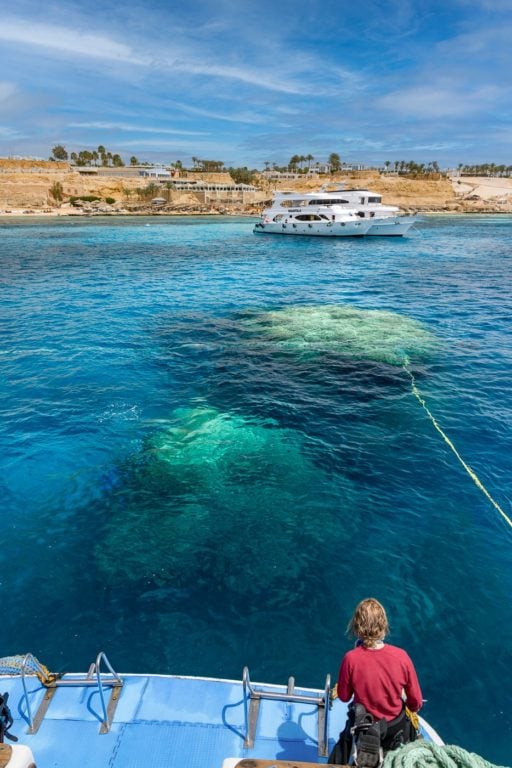 Scuba dive boat next to coral reef in Egypt