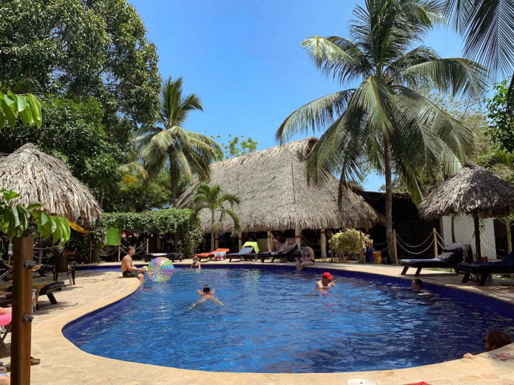 Dreamer Hostel, pool, palm trees and huts