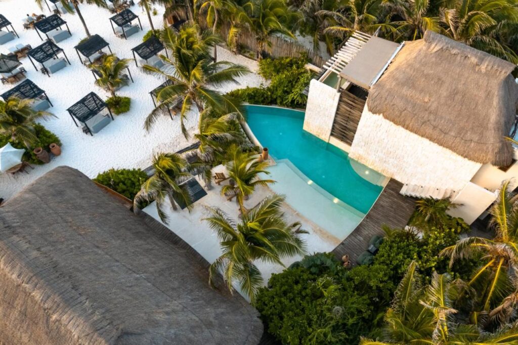 Tulum beach resort with pool and palm trees