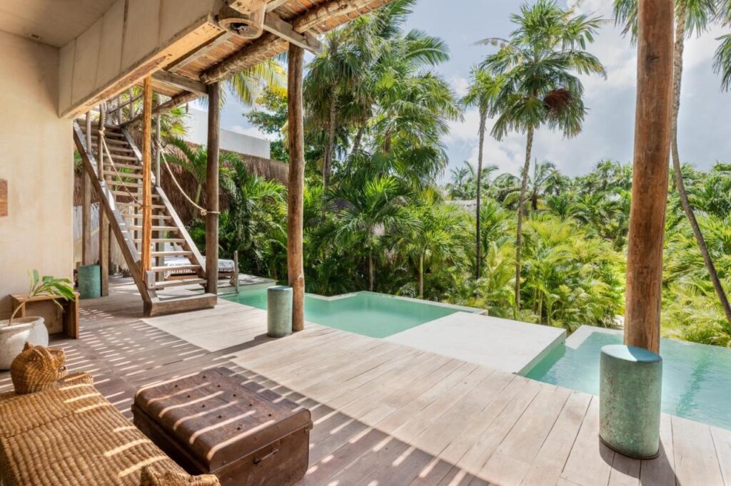 Outdoor pool and views over trees at La Valise Tulum