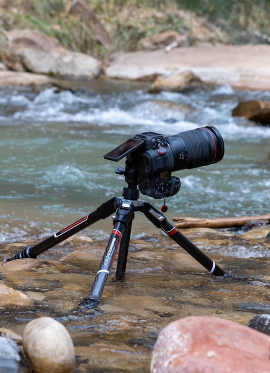 tripod and camera in a river