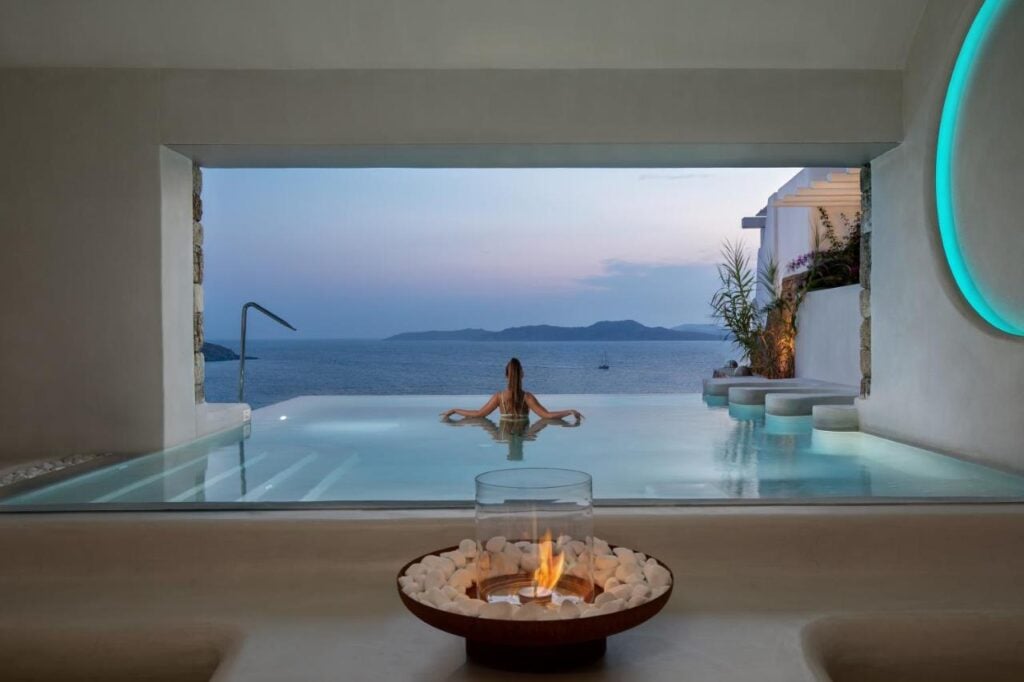 Pool view with woman at Mykonos Grand Hotel & Resort