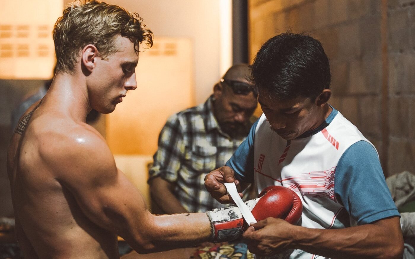 boxer wrapping hands before fighting muay thai in thailand