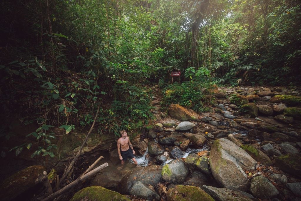 Man swimming in a stream in Reserva Natural Tierra Adentro