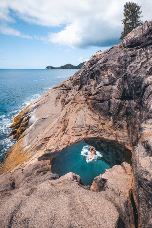 Jumping into the Mahe Rock Pool