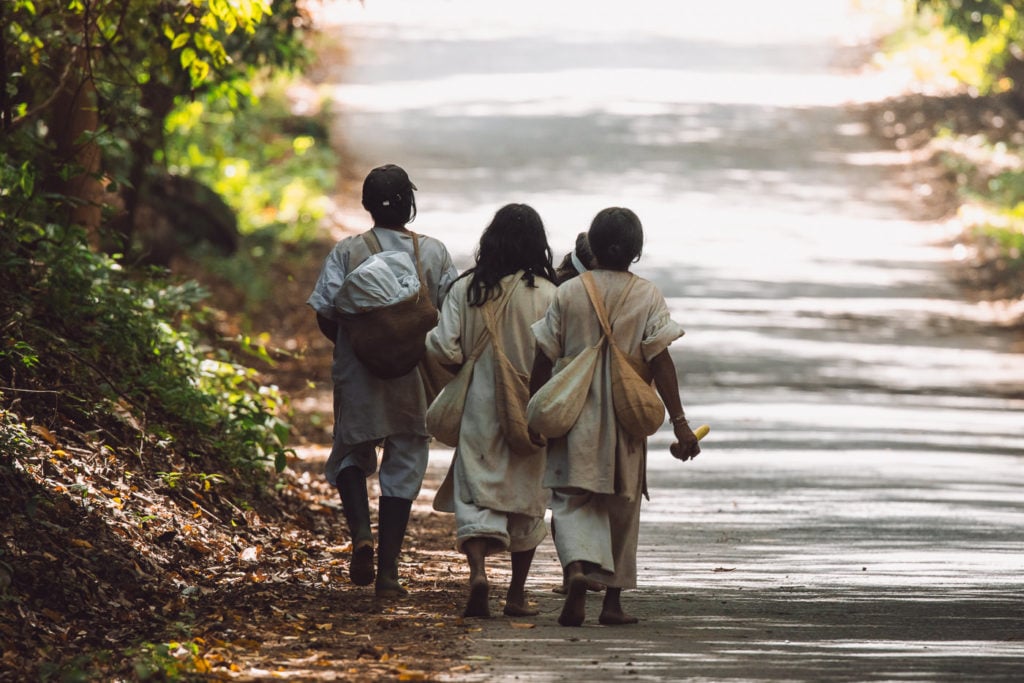 Indigenous people of Wiwa walking on the road in Tayrona National Natural Park, Colombia